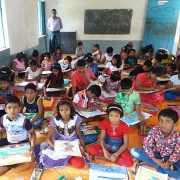 Children showcasing artwork at Kala Kendra annual contest